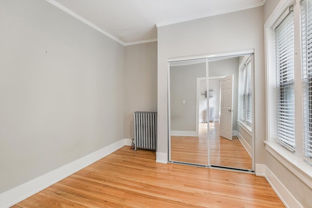 5415 S Dorchester Ave Unit 2B, Chicago, IL 60615 - unfurnished bedroom with radiator, ornamental molding, light wood-style flooring, and baseboards