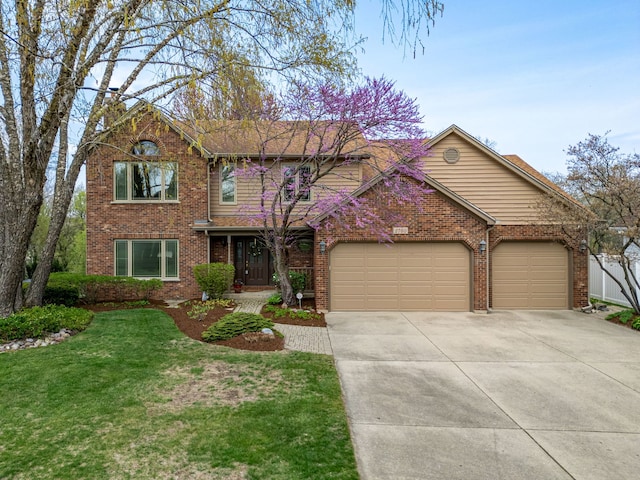 traditional home featuring brick siding, a garage, a front lawn, and driveway