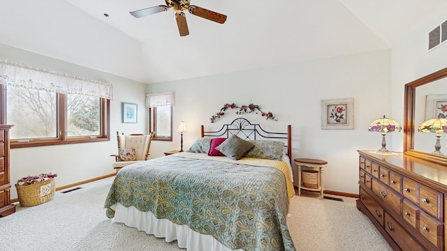 bedroom featuring baseboards, vaulted ceiling, and multiple windows