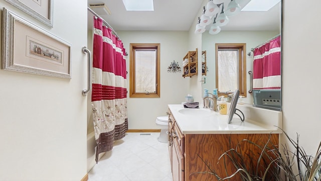 full bath with shower / bath combo, vanity, toilet, baseboards, and a skylight