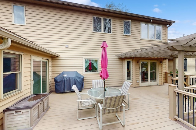 wooden deck with a pergola, a grill, and outdoor dining space