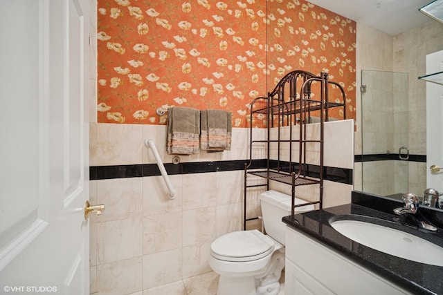 2365 Waukegan Rd Unit 2C, Northbrook, IL 60062 - bathroom featuring a wainscoted wall, wallpapered walls, toilet, tile walls, and vanity