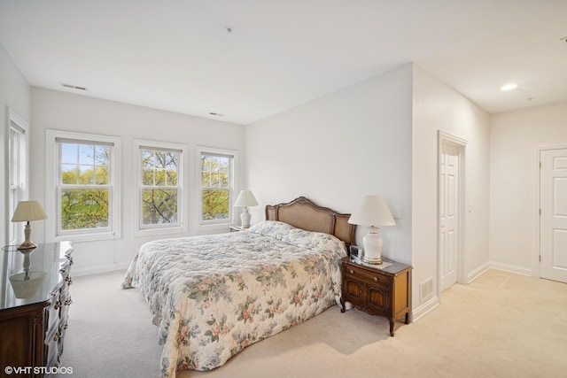 2365 Waukegan Rd Unit 2C, Northbrook, IL 60062 - bedroom featuring visible vents, multiple windows, light carpet, and baseboards