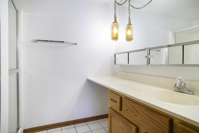 2608 186th St Unit 105, Lansing, IL 60438 - bathroom with baseboards, a shower with shower door, tile patterned floors, and vanity