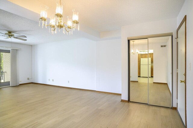 2608 186th St Unit 105, Lansing, IL 60438 - unfurnished room with a textured ceiling, baseboards, visible vents, ceiling fan with notable chandelier, and light wood-style floors