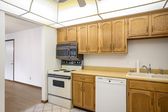 2608 186th St Unit 105, Lansing, IL 60438 - kitchen with light tile patterned floors, a sink, brown cabinetry, white appliances, and light countertops