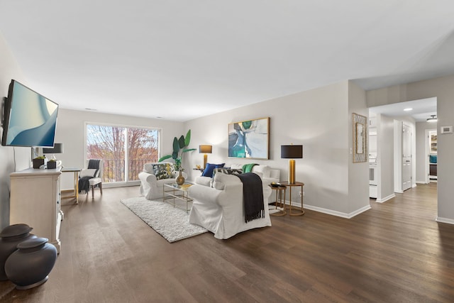 living area with wood finished floors and baseboards