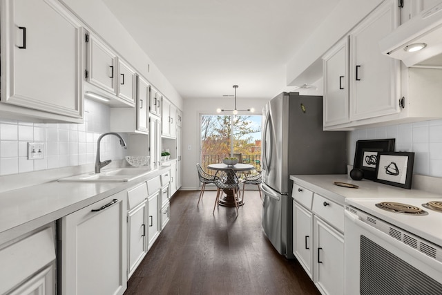 kitchen featuring white electric range oven, under cabinet range hood, a sink, and white cabinetry