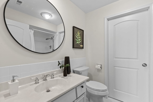 bathroom with toilet, tile walls, visible vents, curtained shower, and vanity