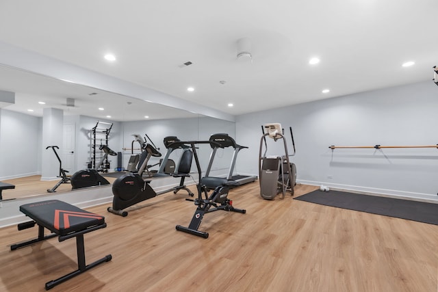 workout area featuring recessed lighting, wood finished floors, and baseboards