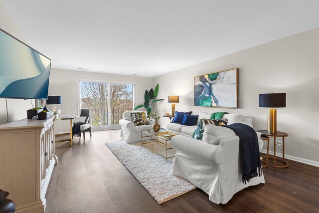 living room featuring wood finished floors and baseboards