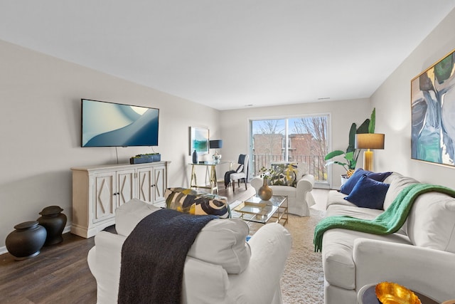 living room featuring wood finished floors and baseboards