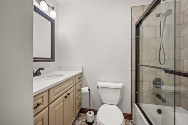 full bathroom with vanity, toilet, bath / shower combo with glass door, and baseboards
