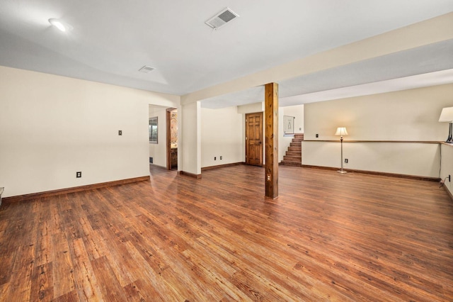 finished basement featuring wood finished floors, baseboards, and stairs