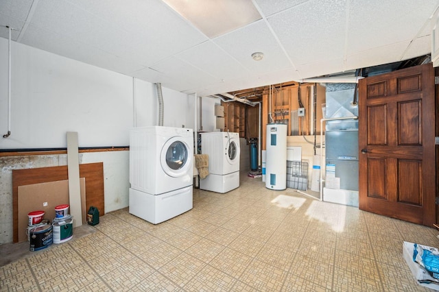 laundry area with washer and dryer, water heater, light floors, and heating unit