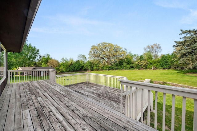 wooden deck with a yard and view of scattered trees