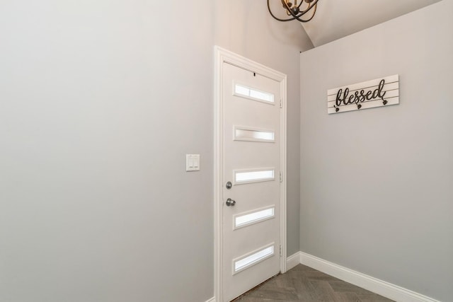 doorway featuring baseboards