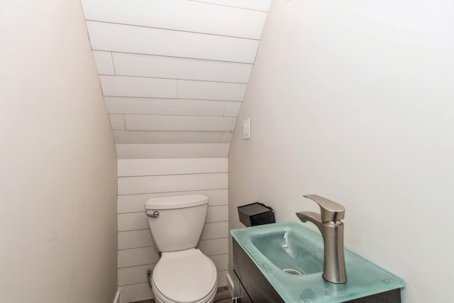 half bathroom with toilet and vanity