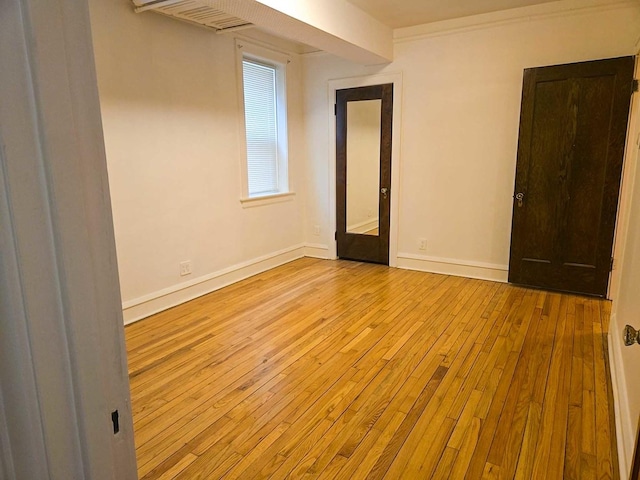 unfurnished room featuring baseboards and hardwood / wood-style flooring
