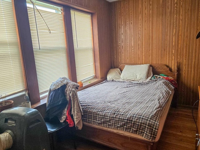 bedroom featuring wooden walls