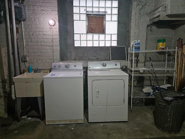 washroom with a sink, laundry area, and washer and dryer