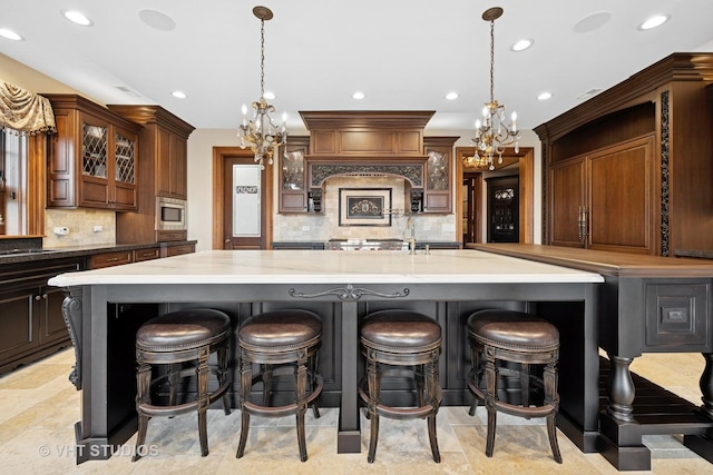 546 Oak Knoll Rd, Barrington Hills, IL 60010 - kitchen with a chandelier, tasteful backsplash, recessed lighting, and a large island with sink