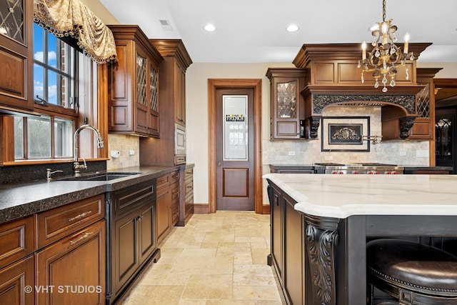546 Oak Knoll Rd, Barrington Hills, IL 60010 - kitchen featuring a sink, stone tile floors, tasteful backsplash, and baseboards