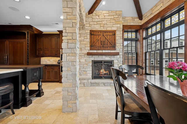 546 Oak Knoll Rd, Barrington Hills, IL 60010 - dining area with stone tile flooring, visible vents, beam ceiling, recessed lighting, and a fireplace