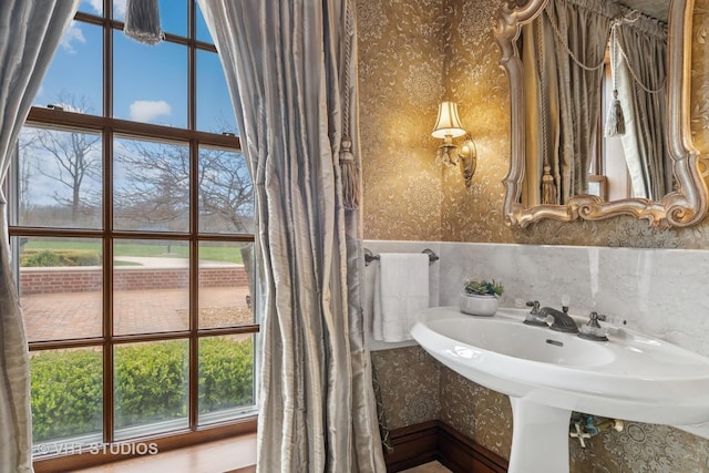 546 Oak Knoll Rd, Barrington Hills, IL 60010 - bathroom with a healthy amount of sunlight, wallpapered walls, and a wainscoted wall