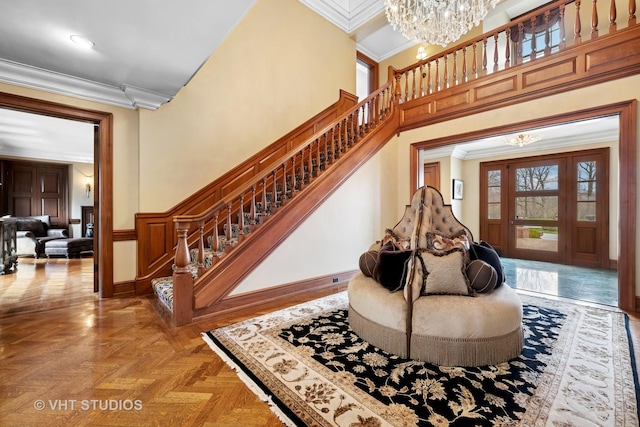 546 Oak Knoll Rd, Barrington Hills, IL 60010 - entrance foyer with crown molding, an inviting chandelier, stairway, and wainscoting