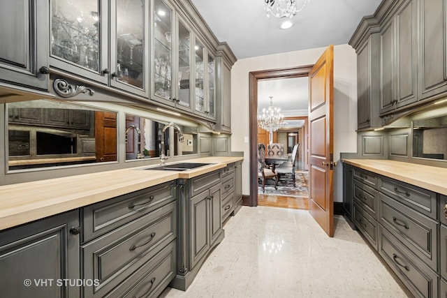 546 Oak Knoll Rd, Barrington Hills, IL 60010 - bar with a chandelier, baseboards, and a sink