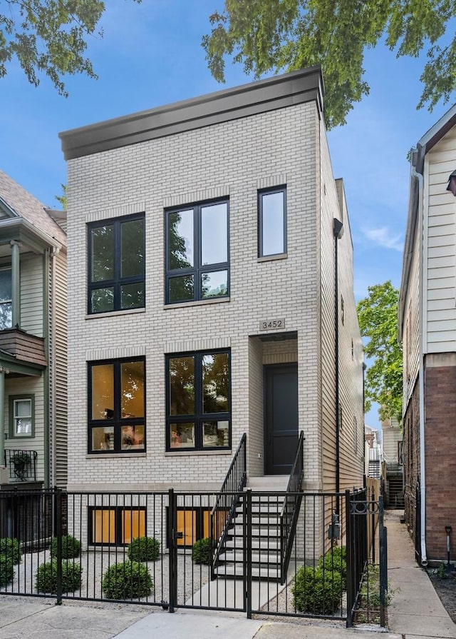 3452 N Bell Ave, Chicago, IL 60618 - contemporary home with brick siding and a fenced front yard