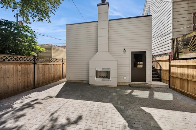 3452 N Bell Ave, Chicago, IL 60618 - fenced backyard featuring a fireplace and a patio