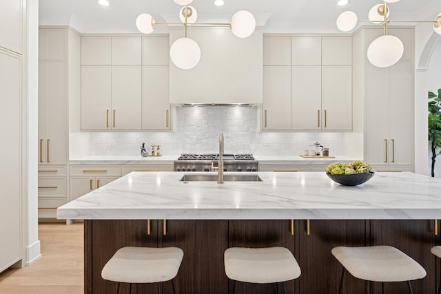 3452 N Bell Ave, Chicago, IL 60618 - kitchen with tasteful backsplash, decorative light fixtures, light stone countertops, a breakfast bar, and recessed lighting