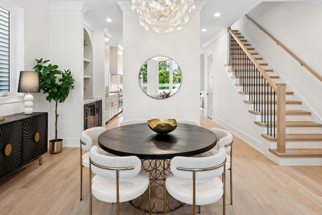 3452 N Bell Ave, Chicago, IL 60618 - dining space featuring stairway, light wood-style floors, a chandelier, crown molding, and recessed lighting