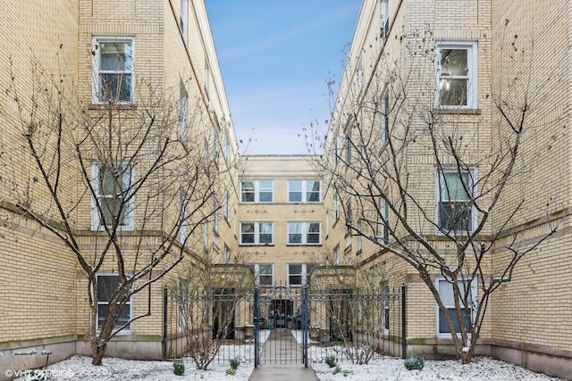 snow covered property featuring a fenced front yard