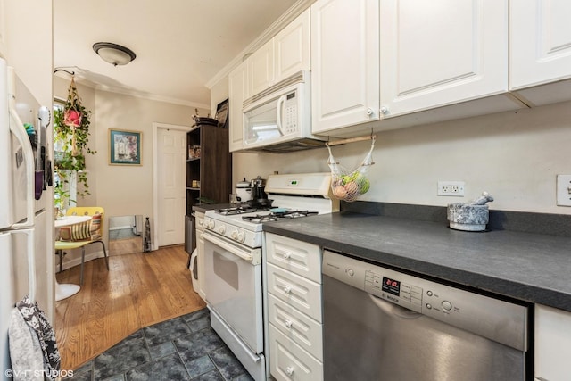 kitchen with white cabinetry, dark countertops, and white appliances