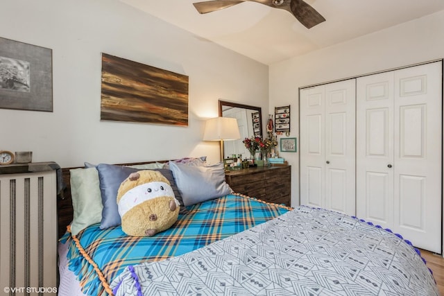 bedroom with wood finished floors, ceiling fan, and a closet