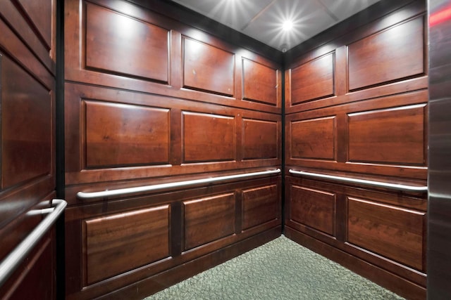 interior details with carpet flooring and elevator
