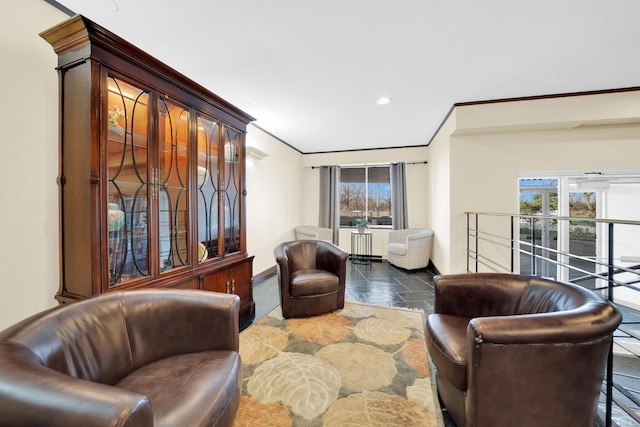 living area with baseboards, a wealth of natural light, recessed lighting, and crown molding