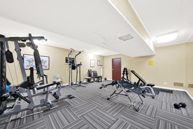 workout area with visible vents, baseboards, and carpet flooring