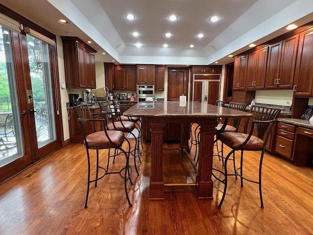 37418 N Fox Hill Dr, Wadsworth, IL 60083 - kitchen featuring paneled built in fridge, a kitchen breakfast bar, light wood-style floors, and a kitchen island