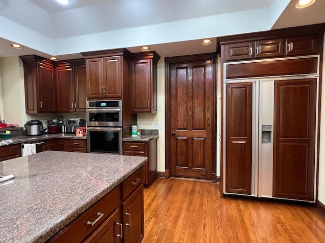 37418 N Fox Hill Dr, Wadsworth, IL 60083 - kitchen with light wood finished floors, dark countertops, recessed lighting, paneled built in refrigerator, and double oven