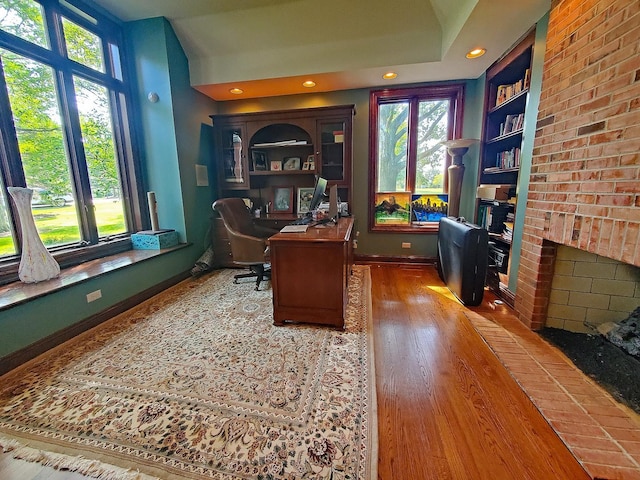 37418 N Fox Hill Dr, Wadsworth, IL 60083 - office space featuring baseboards, recessed lighting, built in shelves, wood finished floors, and a fireplace
