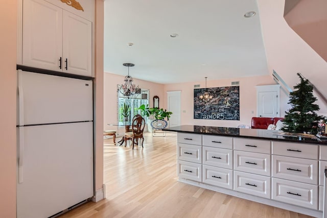 37418 N Fox Hill Dr, Wadsworth, IL 60083 - kitchen featuring white cabinets, light wood finished floors, visible vents, freestanding refrigerator, and a chandelier