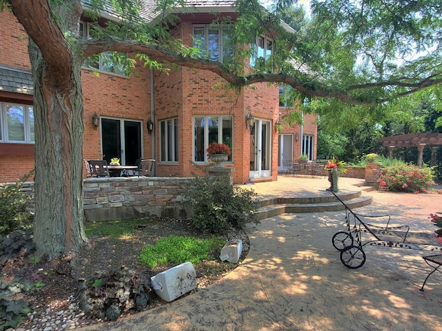 37418 N Fox Hill Dr, Wadsworth, IL 60083 - back of house with brick siding, a patio, and a pergola