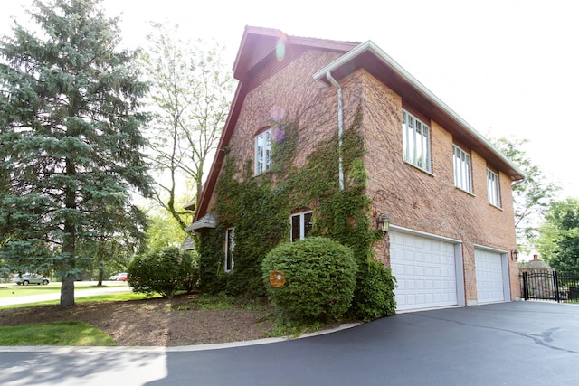 37418 N Fox Hill Dr, Wadsworth, IL 60083 - view of side of home featuring a garage, driveway, and fence