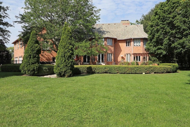 37418 N Fox Hill Dr, Wadsworth, IL 60083 - rear view of property with a yard and a chimney