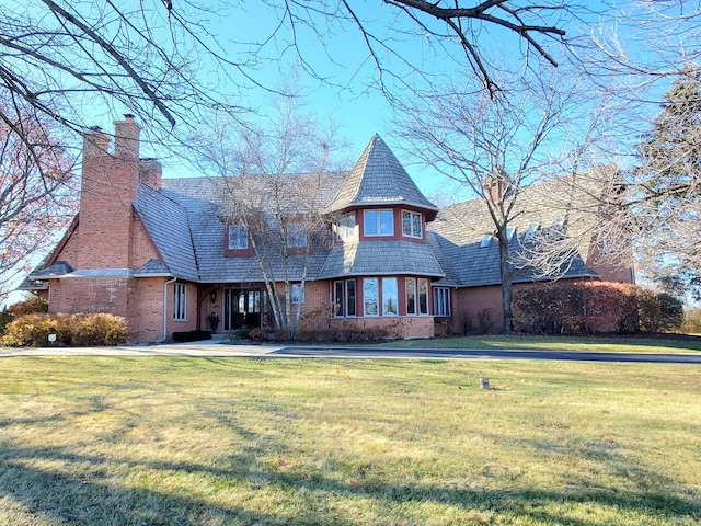 37418 N Fox Hill Dr, Wadsworth, IL 60083 - view of front facade with a chimney, brick siding, and a front yard