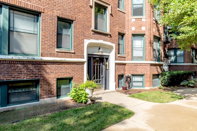 doorway to property with brick siding